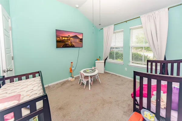 a living room with furniture a window and a flat screen tv