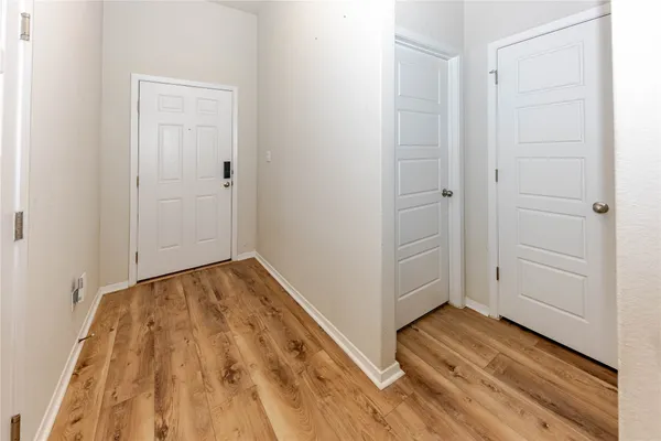 a view of a room with wooden floor and closet