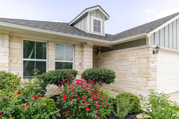 a view of a house with potted plants