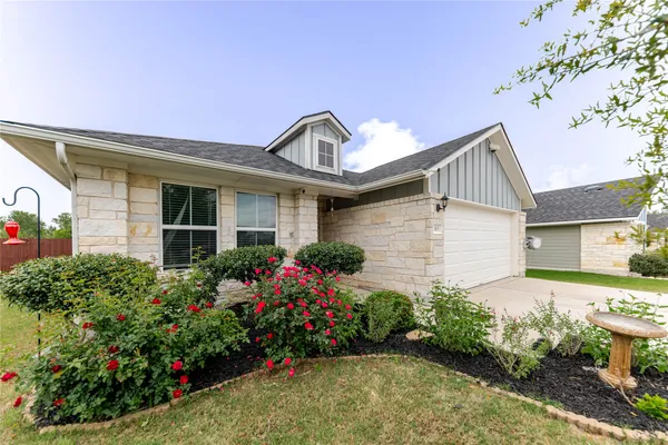 a front view of a house with a garden