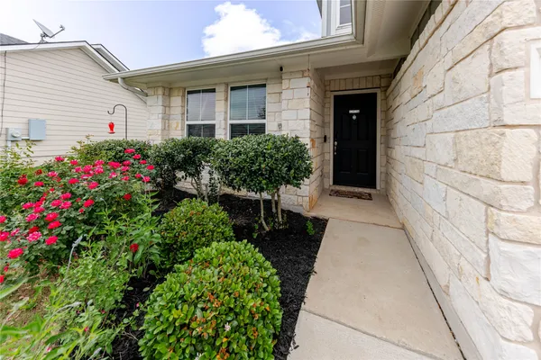 a view of a house with potted plants