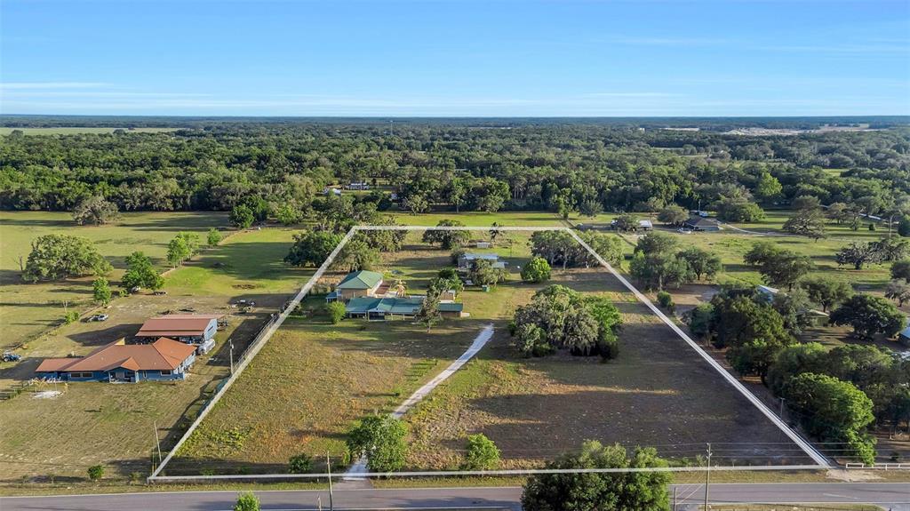 20138 Bowman Road Spring Hill, FL 34610 - Photo 2 of 40 a view of a yard with wooden floor and lake view