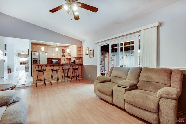 a living room with furniture and kitchen view