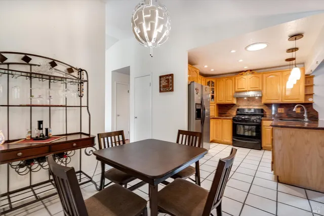 a view of a dining room with furniture and a window