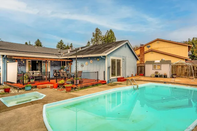 a view of a house with swimming pool and sitting area