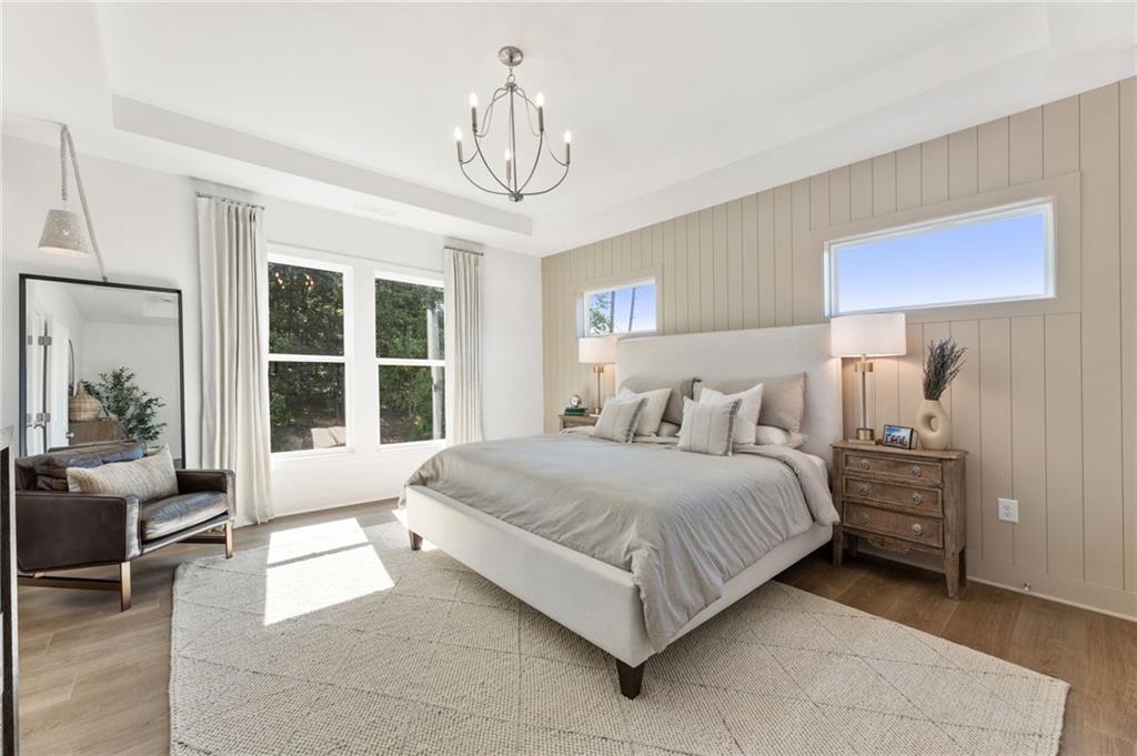 719 Crest Line Trail Powder Springs, GA 30127 - Photo 17 of 29 a spacious bedroom with a bed a table and large window