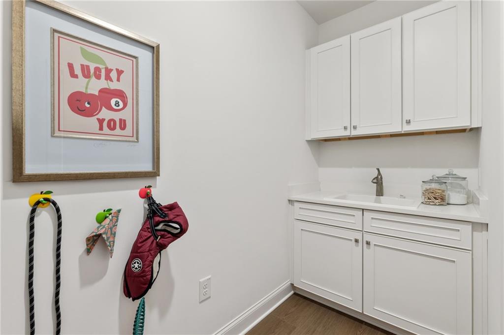 719 Crest Line Trail Powder Springs, GA 30127 - Photo 23 of 29 a bathroom with a sink and a white cabinets