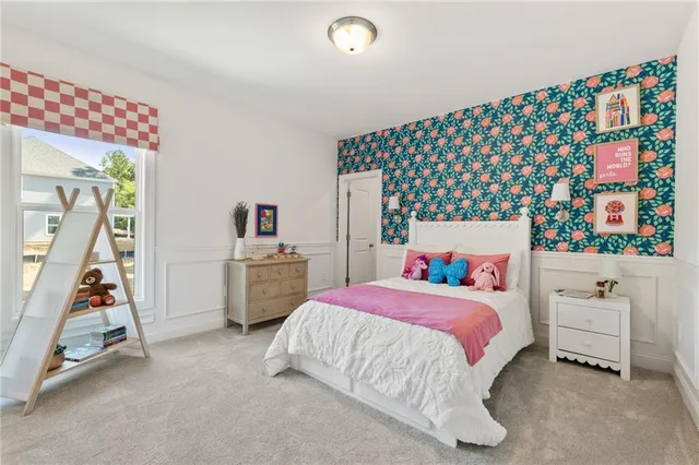 a bedroom with bed and a large window