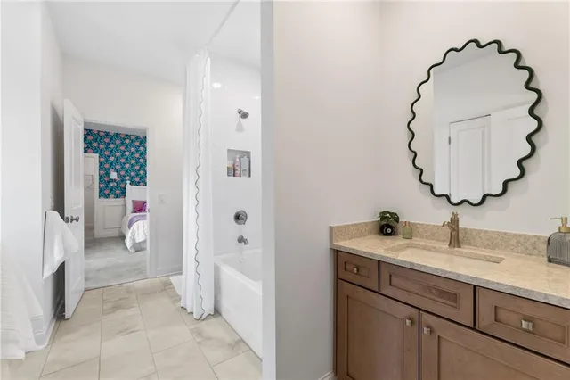 a view of staircase with lots of frames on wall and a window