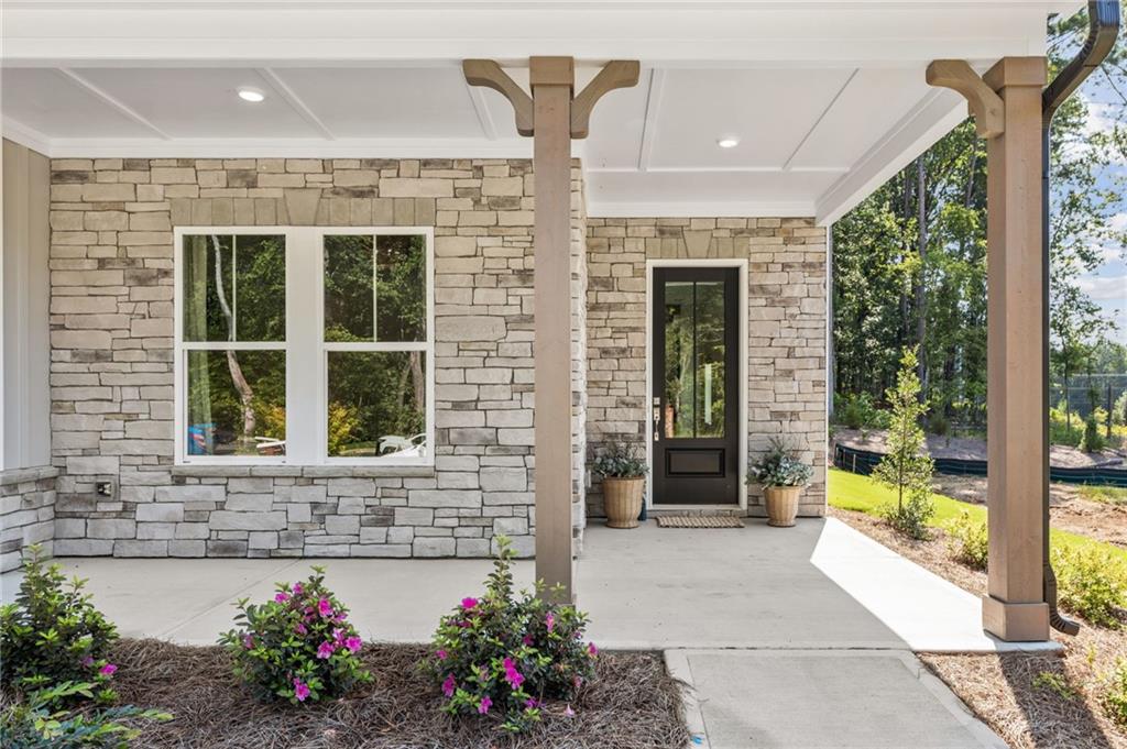 719 Crest Line Trail Powder Springs, GA 30127 - Photo 3 of 29 a front view of a house with a porch