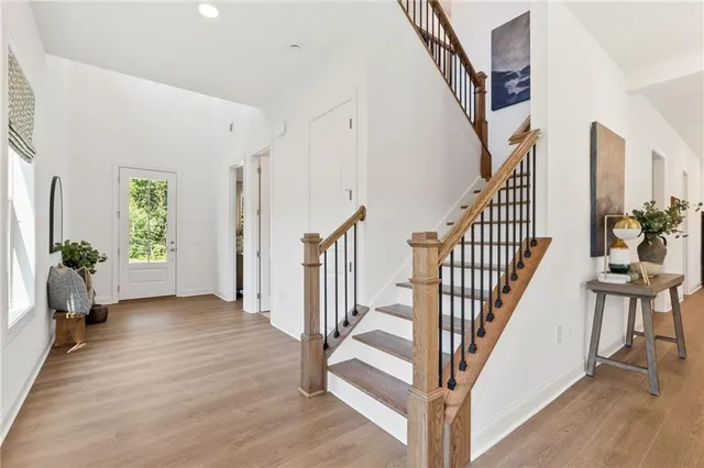a view of an entryway with wooden floor and windows