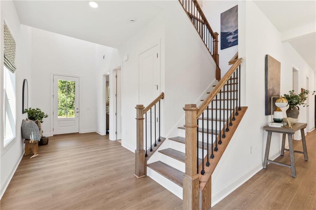 719 Crest Line Trail Powder Springs, GA 30127 - Photo 4 of 29 a view of an entryway with wooden floor and windows