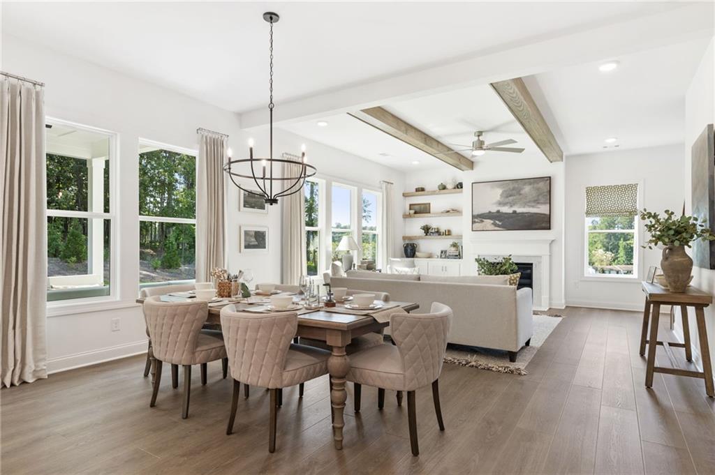 719 Crest Line Trail Powder Springs, GA 30127 - Photo 5 of 29 a view of a dining room with furniture window and wooden floor