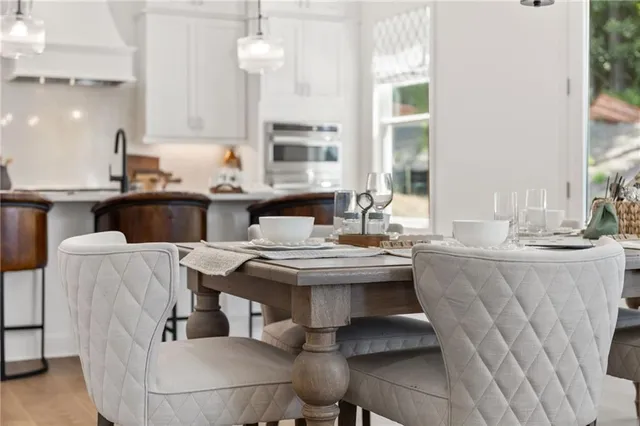 a kitchen with a table chairs stove and kitchen island