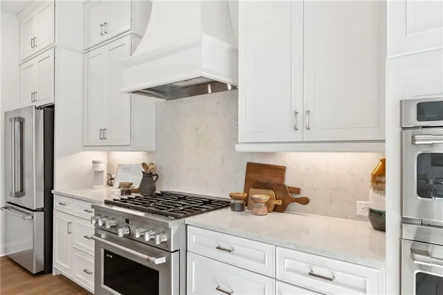 a kitchen with granite countertop a stove and a refrigerator