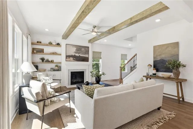 a living room with furniture a fireplace and a flat screen tv