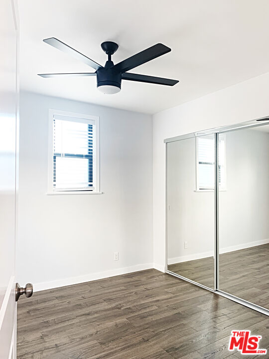 908 North Louise Street, Unit 2 Glendale, CA 91207 - Photo 11 of 15 a view of an empty room with wooden floor and a ceiling fan
