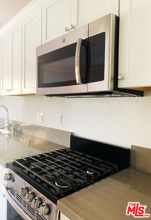 908 North Louise Street, Unit 2 Glendale, CA 91207 - Photo 8 of 15 a kitchen with a stove and a microwave
