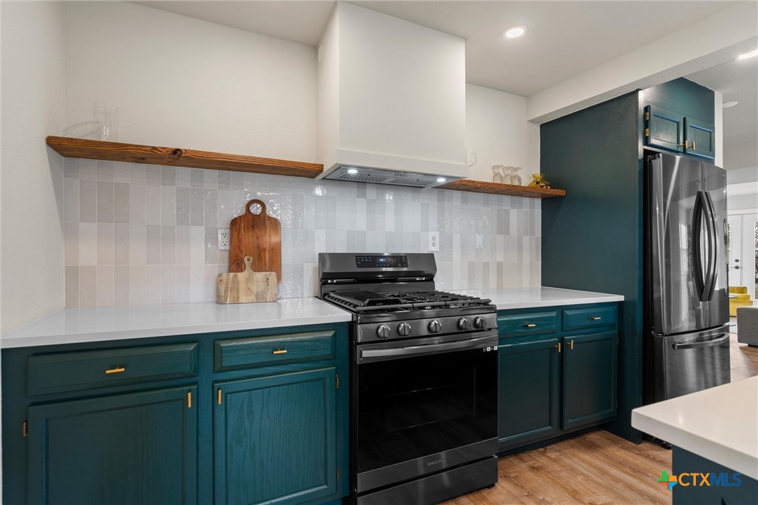836 Cottle Town Road Smithville, TX 78957 - Photo 20 of 47 a kitchen with stainless steel appliances a stove and a refrigerator