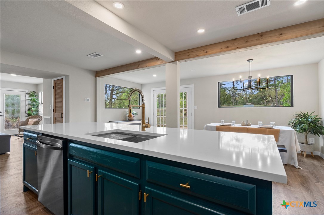 836 Cottle Town Road Smithville, TX 78957 - Photo 21 of 47 a kitchen with center island and large windows