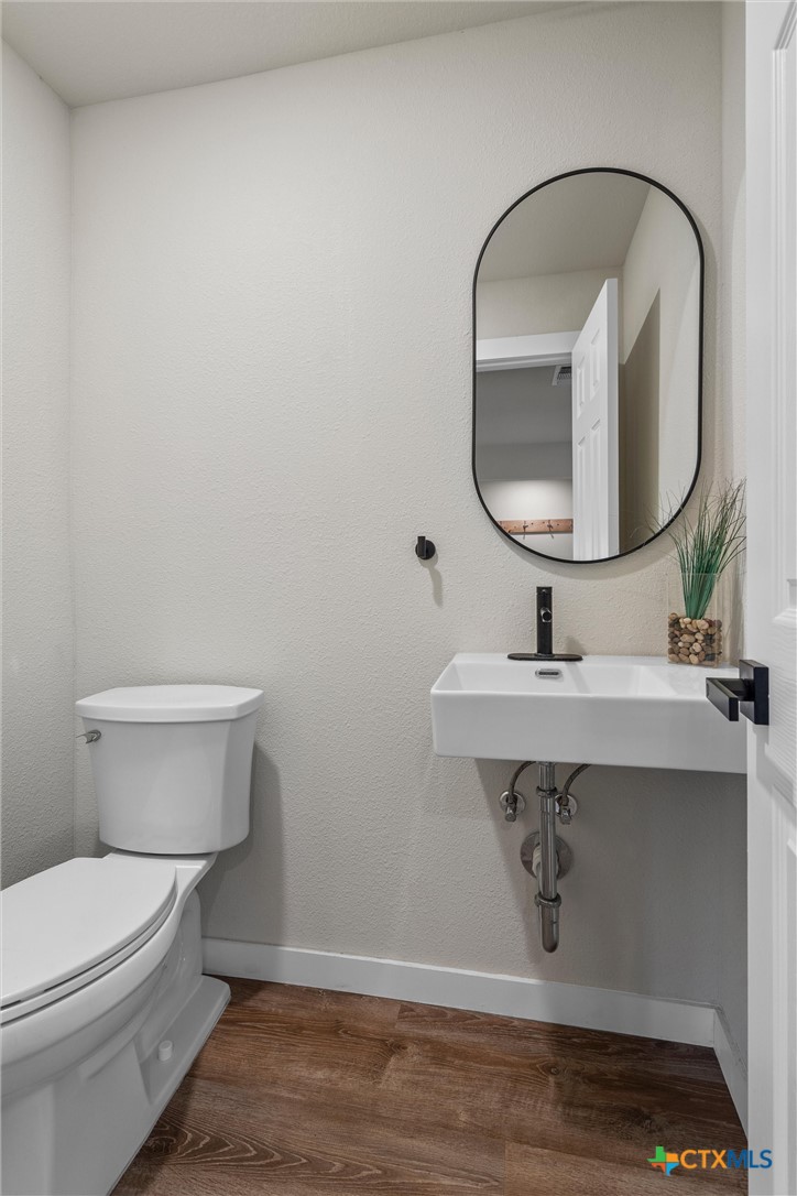 836 Cottle Town Road Smithville, TX 78957 - Photo 31 of 47 a bathroom with a toilet sink and mirror