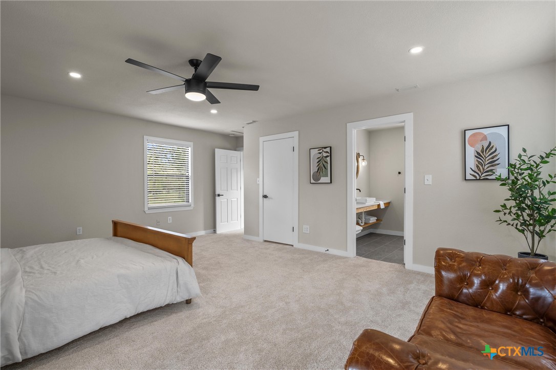 836 Cottle Town Road Smithville, TX 78957 - Photo 36 of 47 a spacious bedroom with a bed and a couch