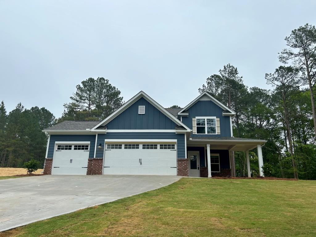 4015 Bullock Bridge Road Loganville, GA 30052 - Photo 1 of 1 a view of a house with a yard and large trees