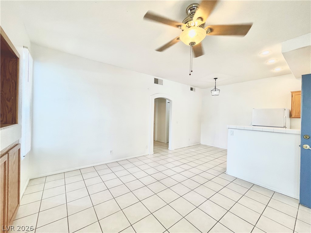 2201 Ramsgate Drive, Unit 915 Henderson, NV 89074 - Photo 19 of 36 A versatile open space features tile flooring and abundant lighting, ready for personalized living.