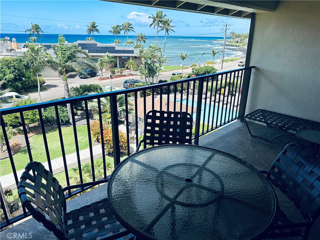 5017 Lawai Road Koloa, HI 96756 - Photo 2 of 10 a balcony with a potted plant on wooden floor