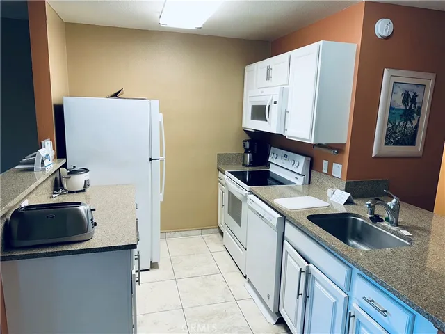 a kitchen with a sink stove and refrigerator