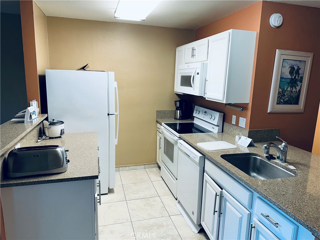 5017 Lawai Road Koloa, HI 96756 - Photo 4 of 10 a kitchen with a sink stove and refrigerator