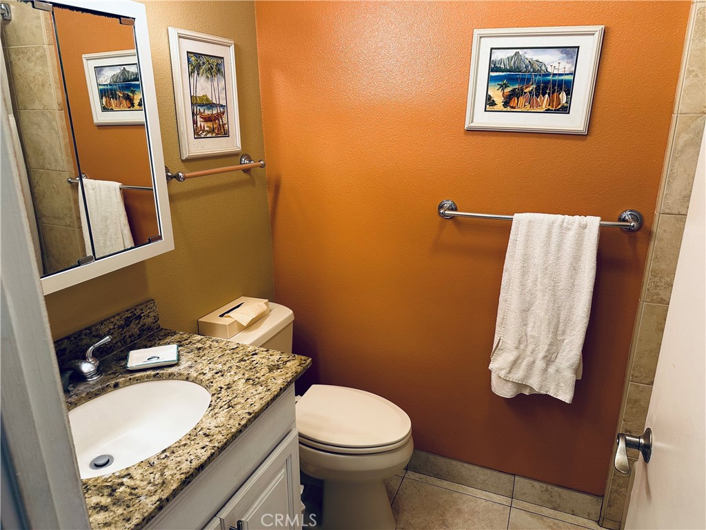 5017 Lawai Road Koloa, HI 96756 - Photo 6 of 10 a bathroom with a granite countertop toilet and a sink