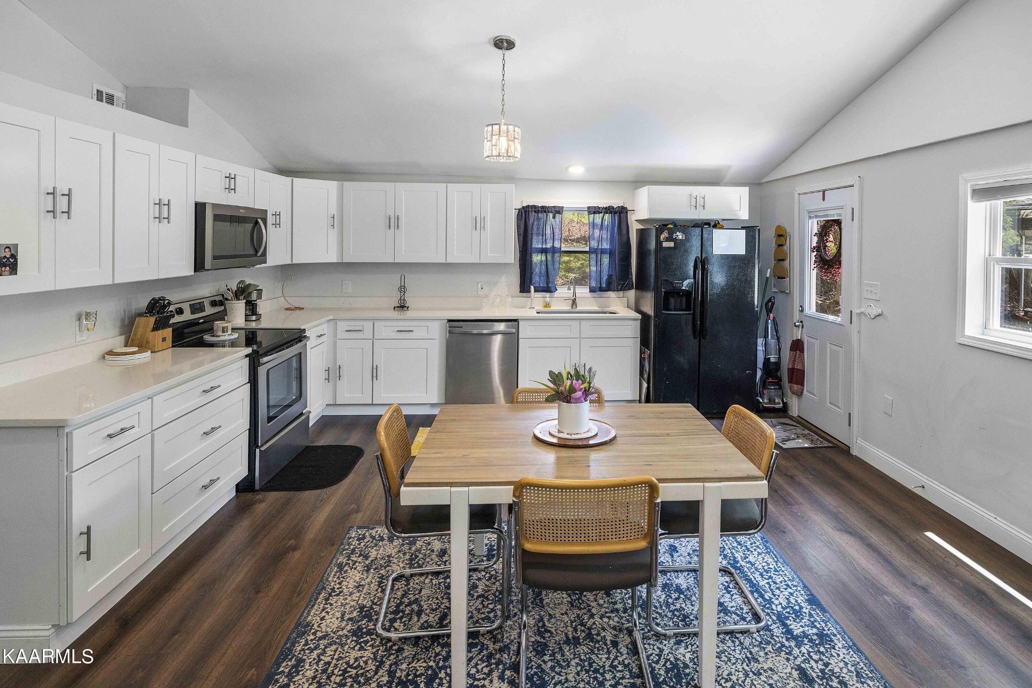 1000 Tarklin Valley Road Knoxville, TN 37920 - Photo 11 of 26 a kitchen with a dining table chairs and refrigerator