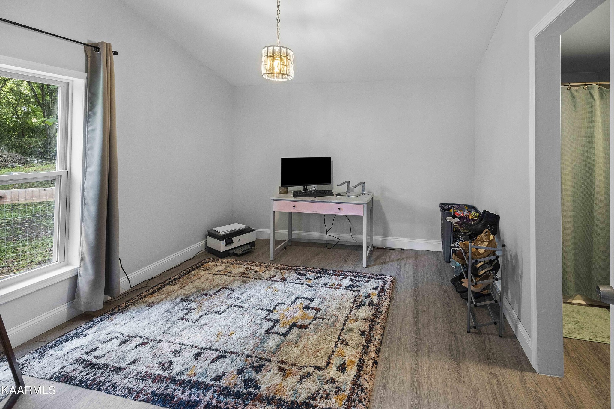 1000 Tarklin Valley Road Knoxville, TN 37920 - Photo 19 of 26 a bedroom with a bed and wooden floor