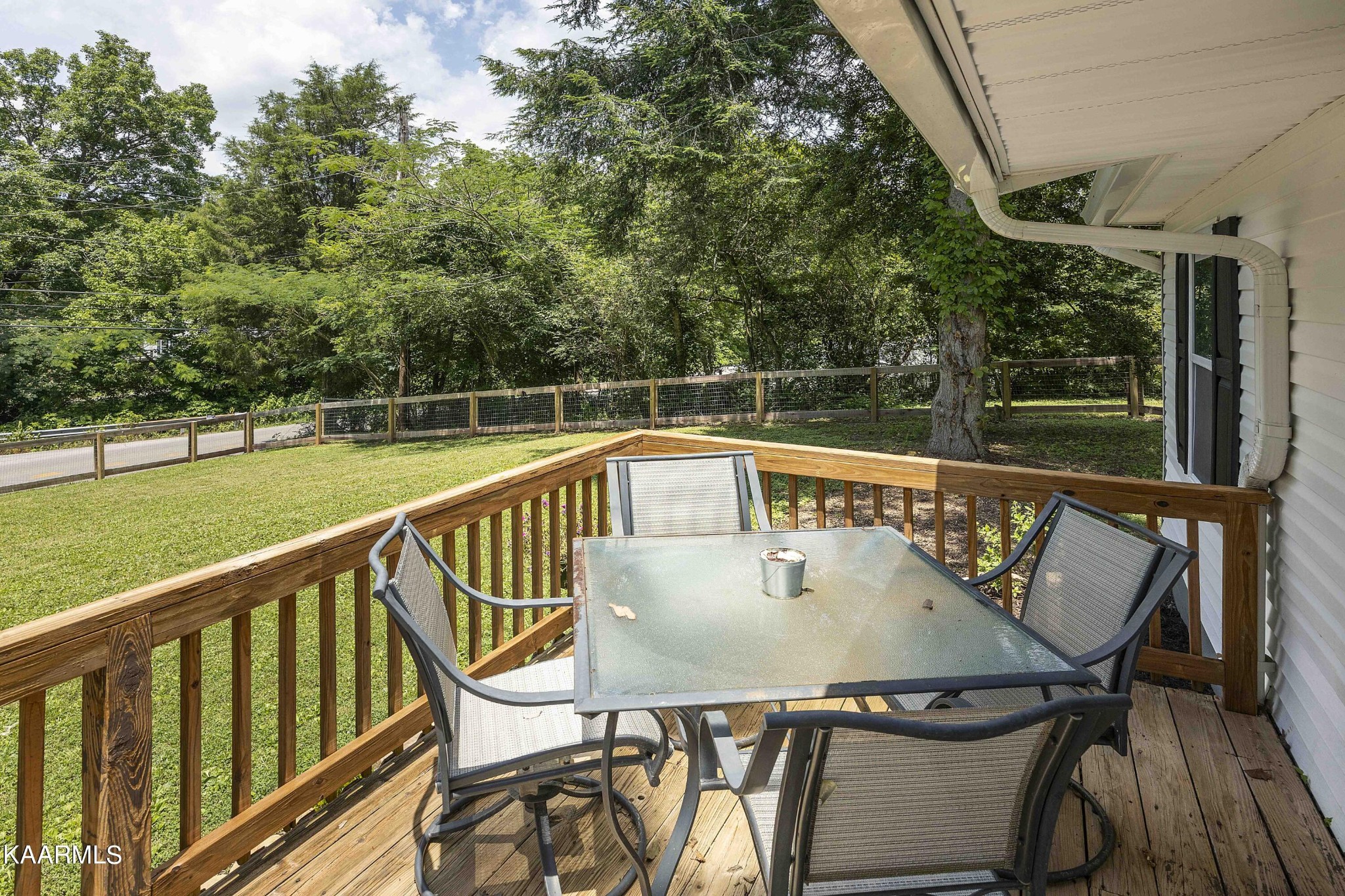 1000 Tarklin Valley Road Knoxville, TN 37920 - Photo 8 of 26 a roof deck with table and chairs and wooden floor