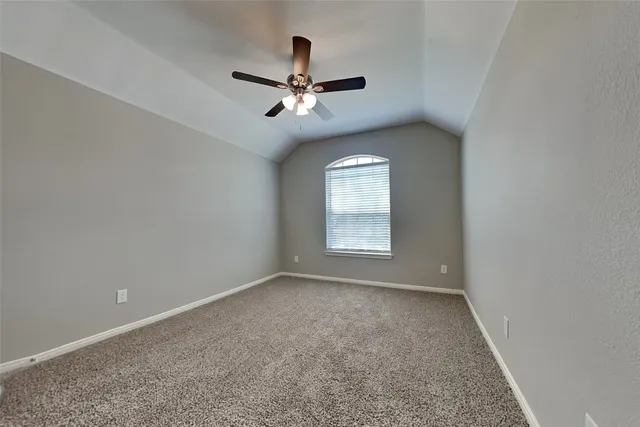 a view of room with a ceiling fan and window