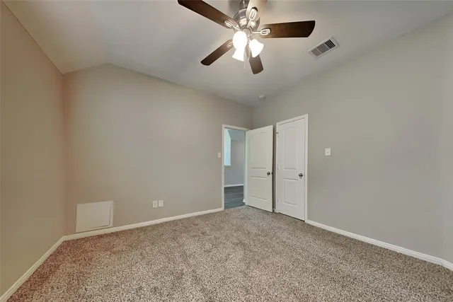 an empty room with a empty space and a ceiling fan
