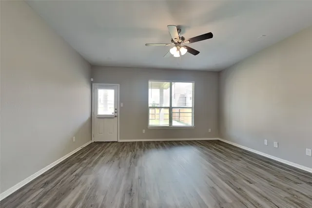 a view of wooden floor and windows in a room