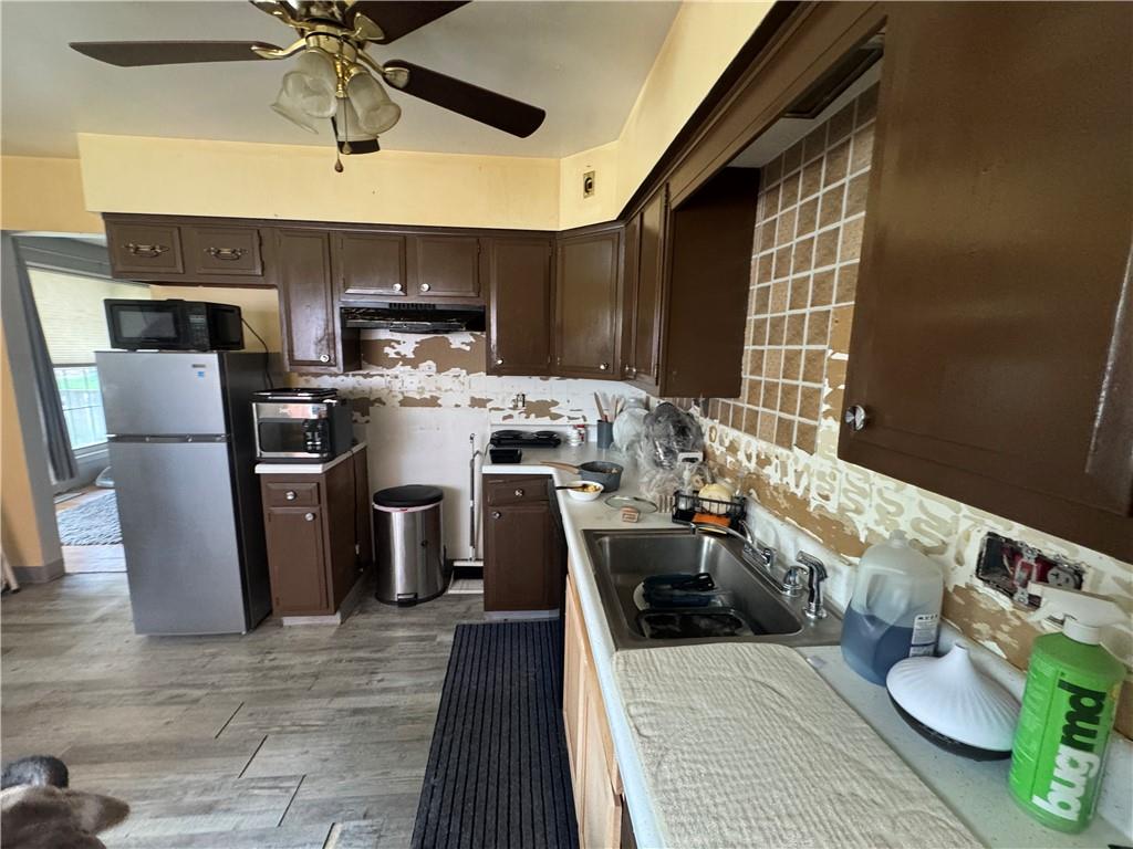 215 Maple Street Kittanning, PA 16201 - Photo 13 of 39 a kitchen with stainless steel appliances a sink a stove top oven a chimney and a dining table