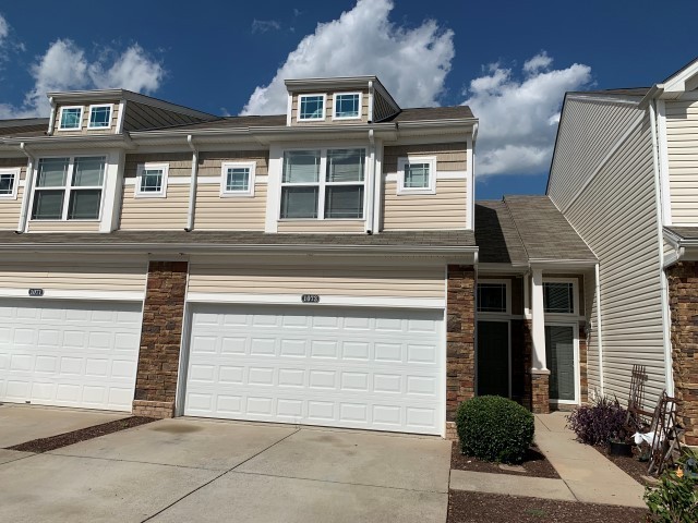 a view of outdoor space garage and residential houses