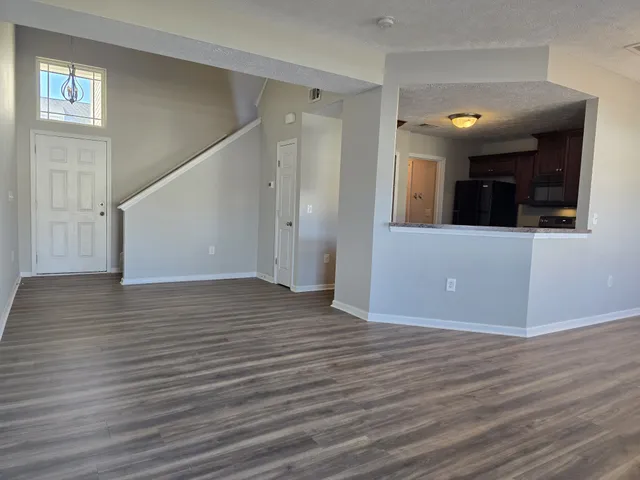 an empty room with a ceiling fan and window