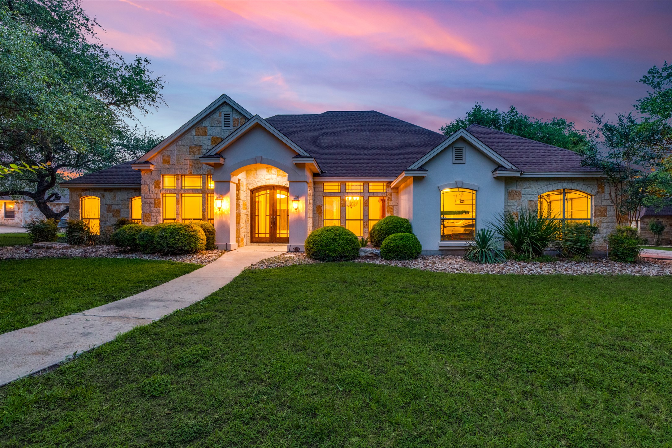 101 Copper Leaf Court Georgetown, TX 78633 - Photo 2 of 31 Stone and stucco exterior featuring a prominent arched entryway with double doors