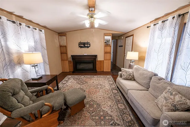 a living room with furniture a fireplace and a flat screen tv