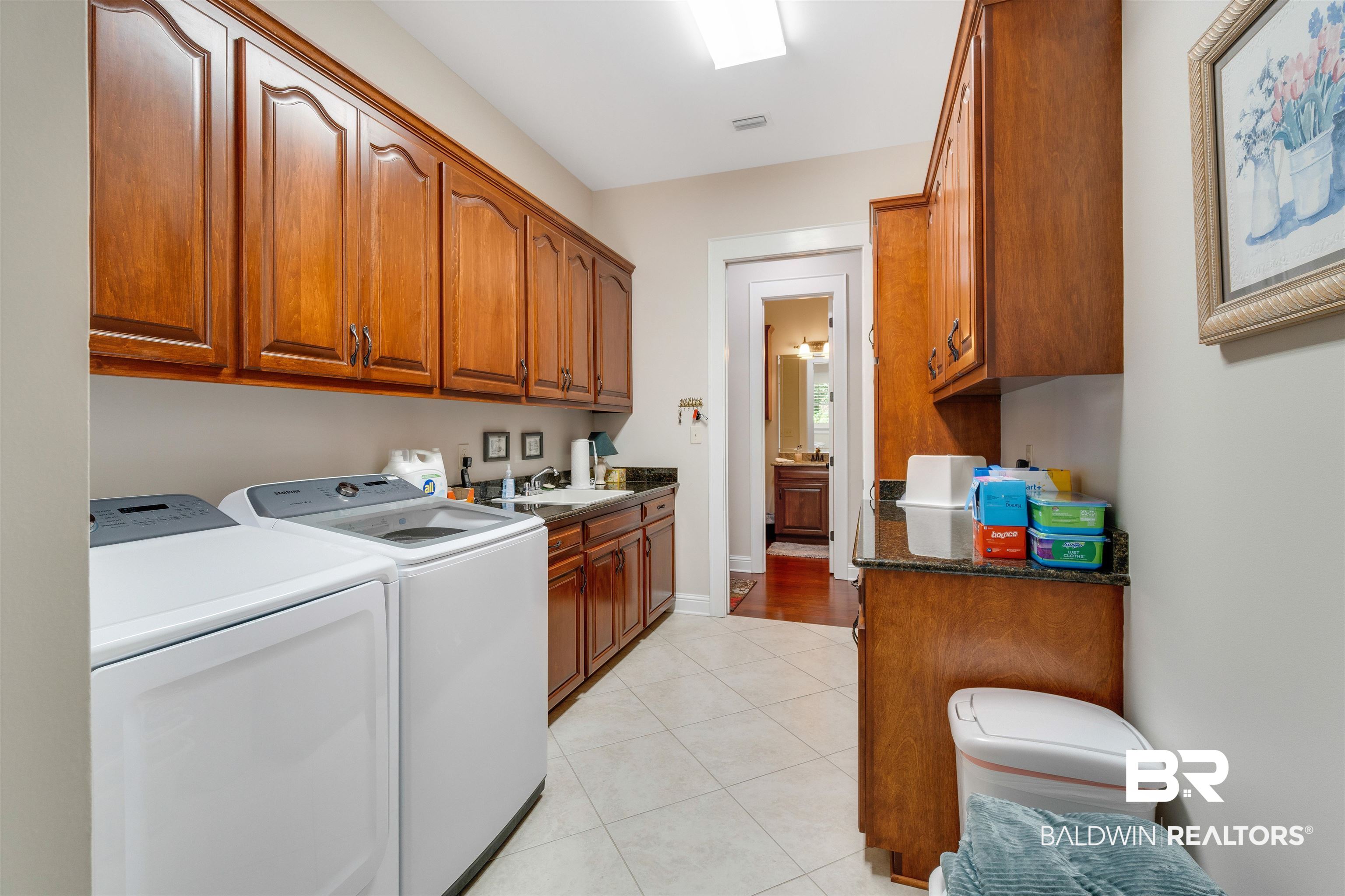 11281 Redfern Road Daphne, AL 36526 - Photo 63 of 80 Laundry area with light wood-type flooring, cabinets, washing machine and dryer, and sink