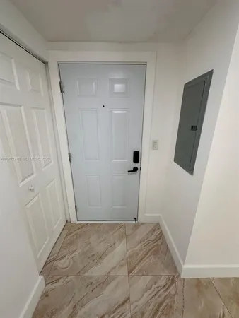 en empty room with window and wooden floor