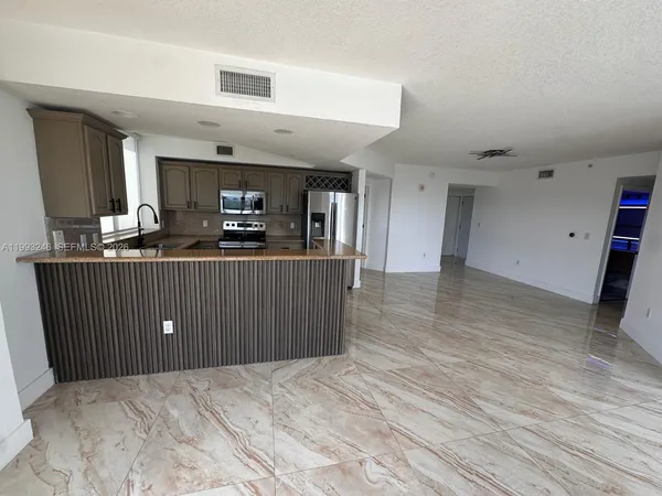 a kitchen with granite countertop wooden cabinets and sink