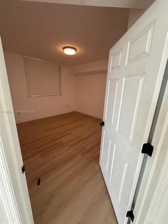 a view of a room with wooden floor