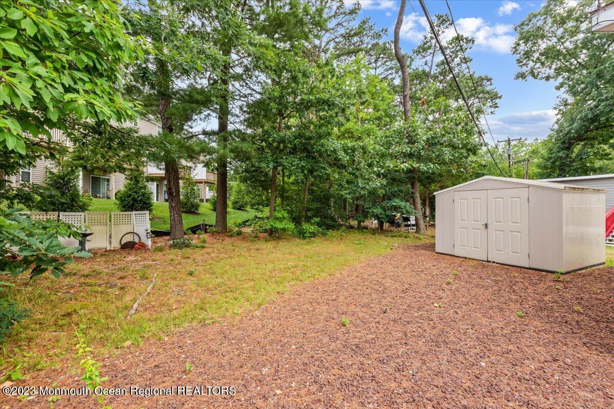 20 Roberts Road Toms River, NJ 08755 - Photo 4 of 17 a view of a backyard with large trees and plants