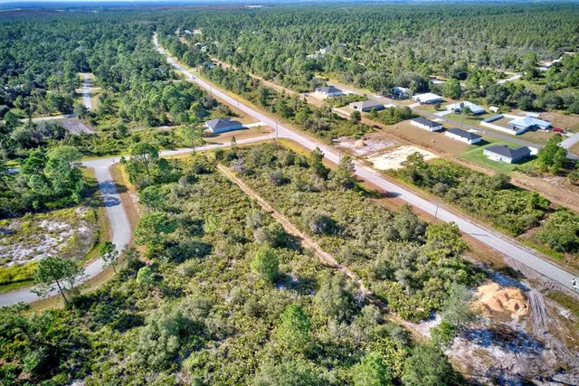 an aerial view of residential houses with outdoor space