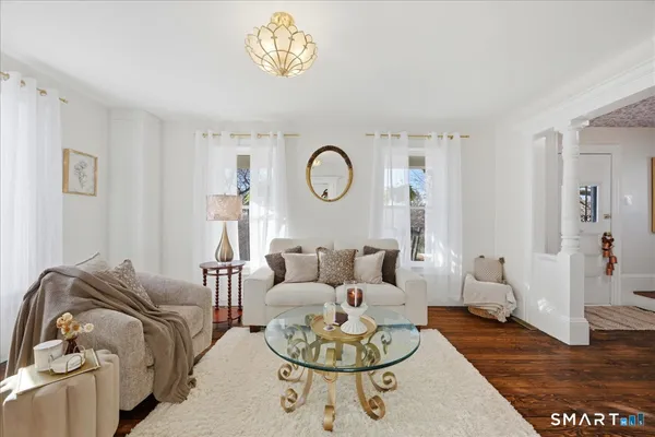 a living room with furniture a rug and a window